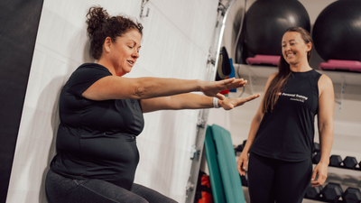 A woman personal training another woman
