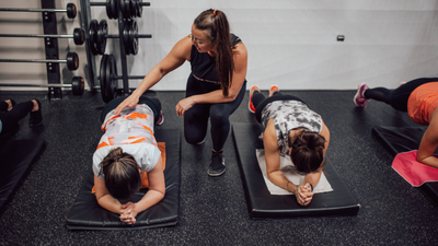 A person trainer working with a team of women
